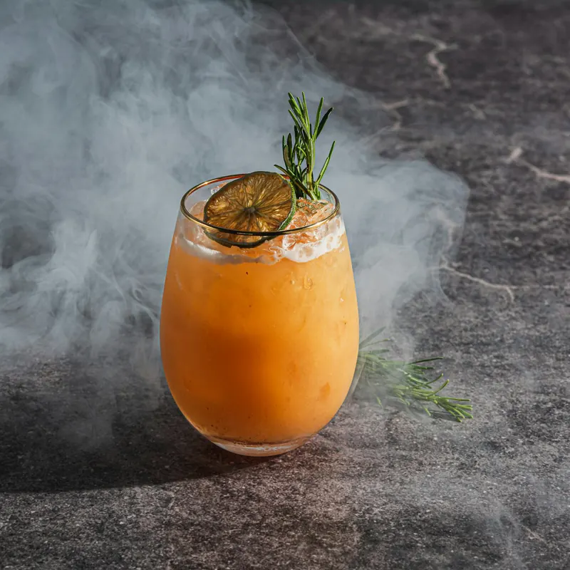 Stock photo: a cocktail on charcoal stone with drifting haze