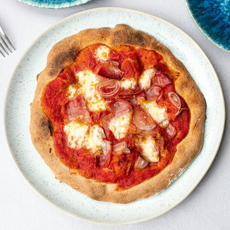 Stock photo: a pizza on a speckled plate from above